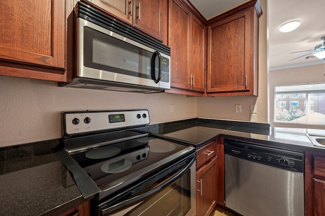 kitchen featuring ceiling fan, stainless steel appliances, and crown molding