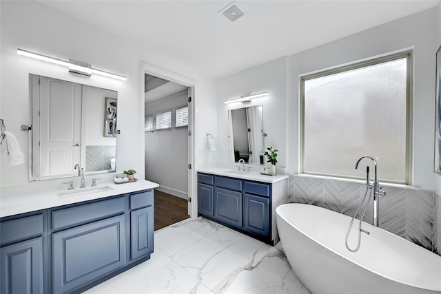 bathroom with vanity and a bathtub