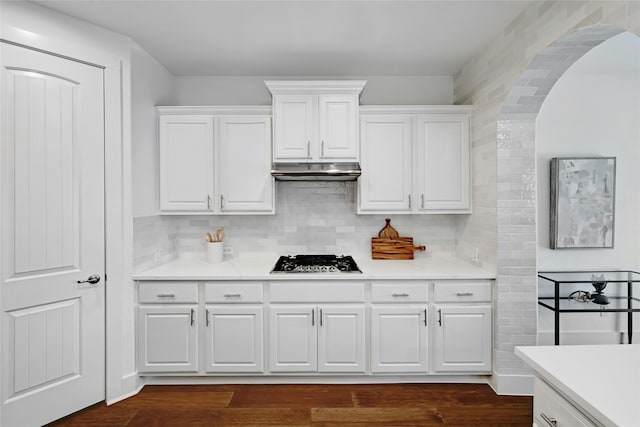 kitchen with gas stovetop, dark hardwood / wood-style floors, decorative backsplash, and white cabinetry