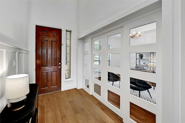 foyer featuring light hardwood / wood-style floors and a notable chandelier