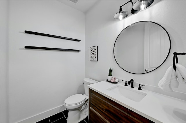 bathroom featuring toilet, tile patterned flooring, and vanity