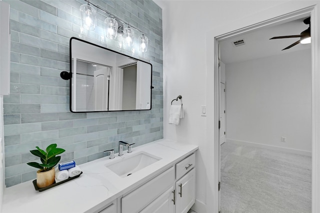 bathroom with vanity, ceiling fan, and tasteful backsplash