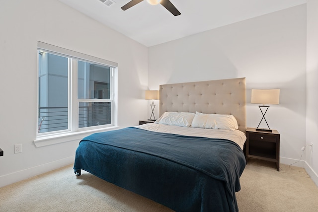 bedroom with ceiling fan and light carpet