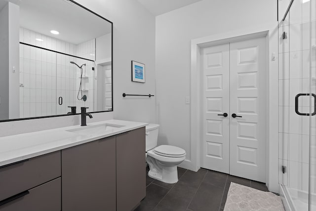 bathroom with toilet, an enclosed shower, tile patterned flooring, and vanity