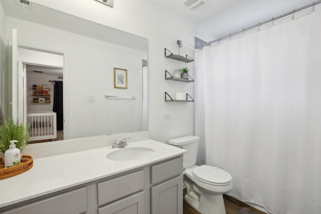 bathroom with toilet and vanity