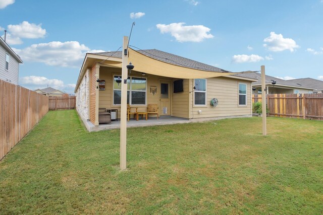 back of property with a patio area and a lawn