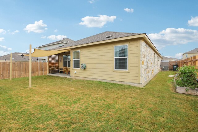 rear view of property with a lawn and a patio