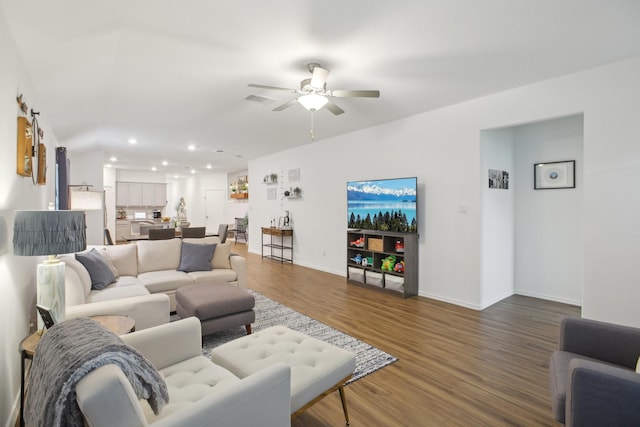 living room with ceiling fan and dark hardwood / wood-style floors