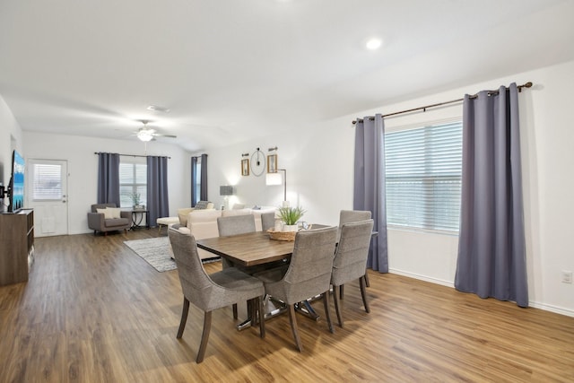 dining space with ceiling fan and wood-type flooring