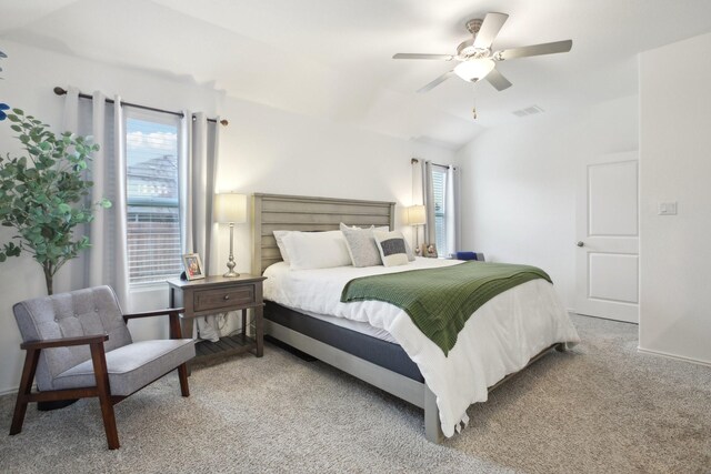 bedroom with lofted ceiling, ceiling fan, and carpet flooring