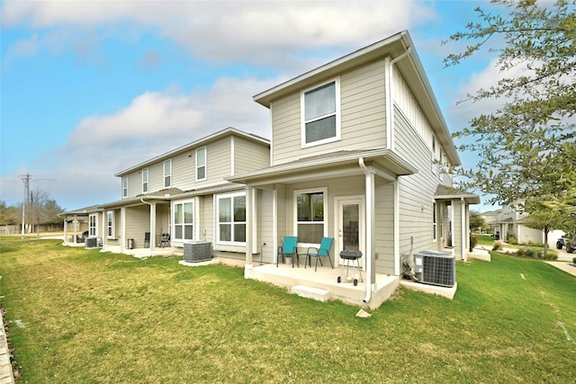 rear view of house featuring a yard, a patio, and central AC unit