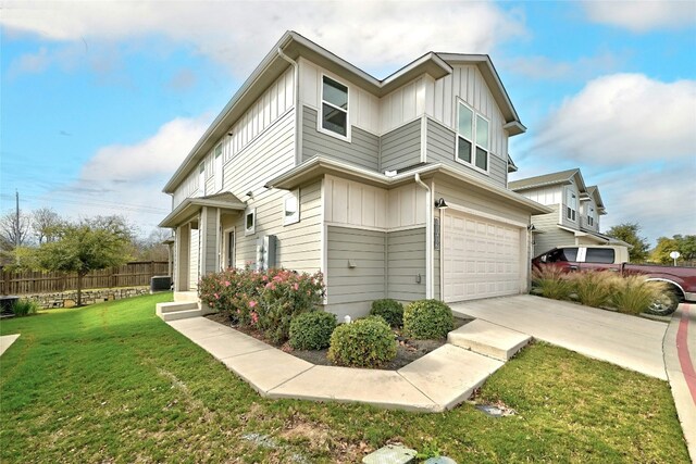 view of front of home featuring a front yard and a garage