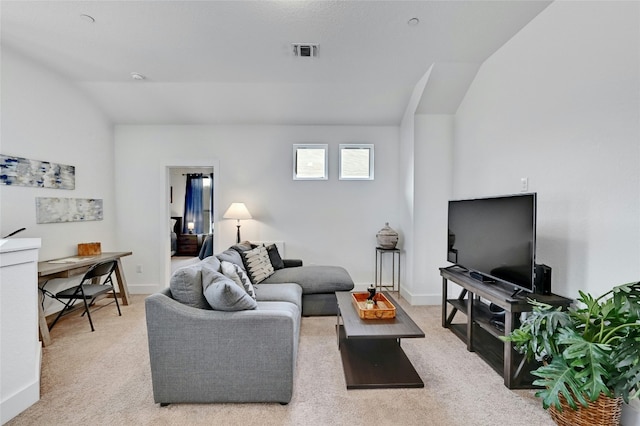 living room featuring light carpet, baseboards, visible vents, and vaulted ceiling