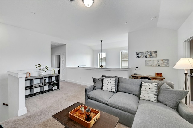 living room with vaulted ceiling, baseboards, and light colored carpet