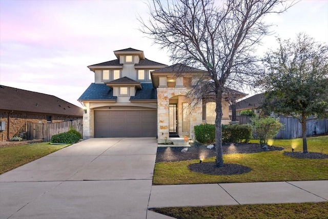 view of front of property with a yard and a garage