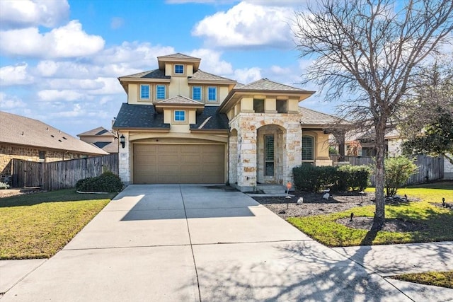 view of front of property with a front yard and a garage