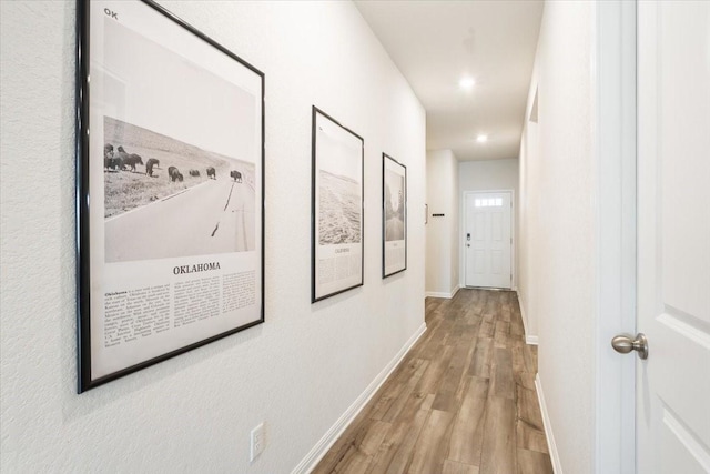 corridor with light hardwood / wood-style flooring