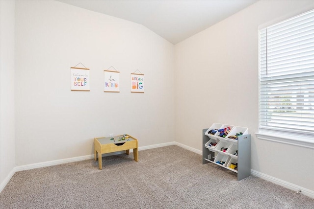 recreation room featuring lofted ceiling and carpet flooring