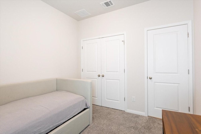 bedroom featuring light carpet