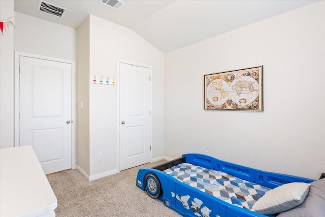 bedroom featuring vaulted ceiling and light colored carpet