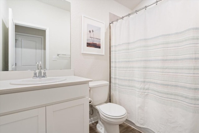 bathroom featuring hardwood / wood-style floors, vanity, and toilet