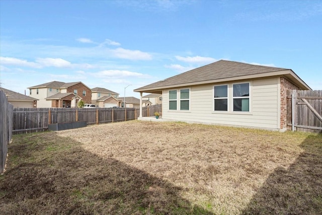 rear view of property featuring a lawn