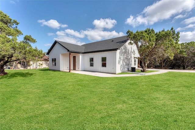 rear view of property featuring a patio area and a lawn