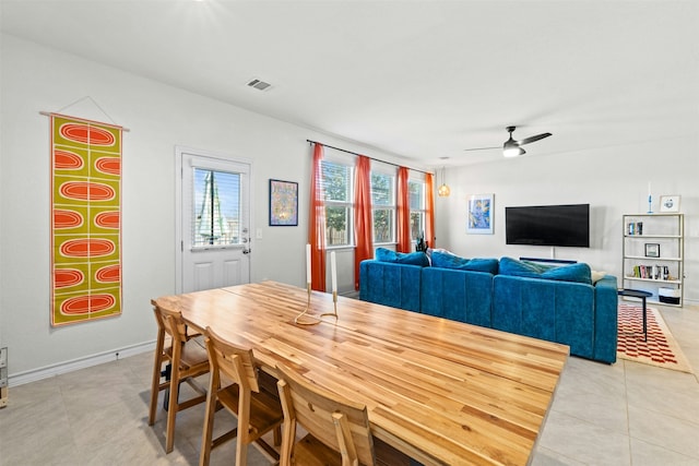 dining space featuring ceiling fan and light tile patterned floors