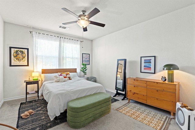 bedroom featuring light carpet and ceiling fan