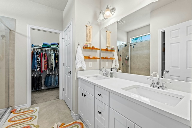 bathroom with vanity, tile patterned flooring, and a shower with shower door