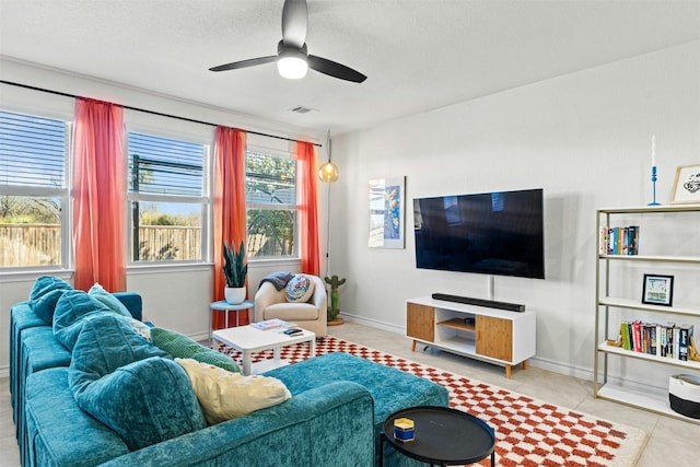 living room with ceiling fan and light tile patterned floors