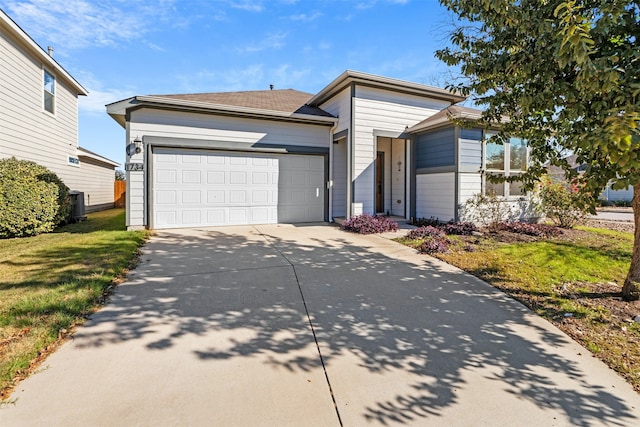 view of front of home with a front yard and a garage