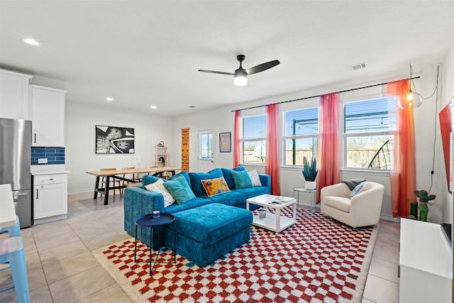 living room with ceiling fan and light tile patterned flooring