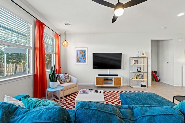 tiled living room with ceiling fan