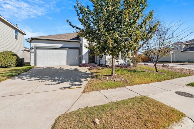 view of front of home with central AC unit, a front yard, and a garage