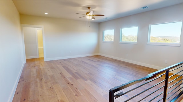 unfurnished room featuring recessed lighting, visible vents, light wood-style floors, a ceiling fan, and baseboards