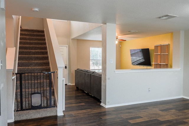 unfurnished living room with ceiling fan and dark hardwood / wood-style floors