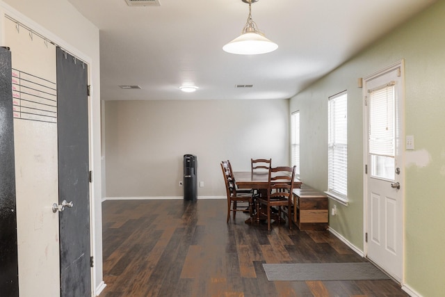 dining space with dark hardwood / wood-style flooring