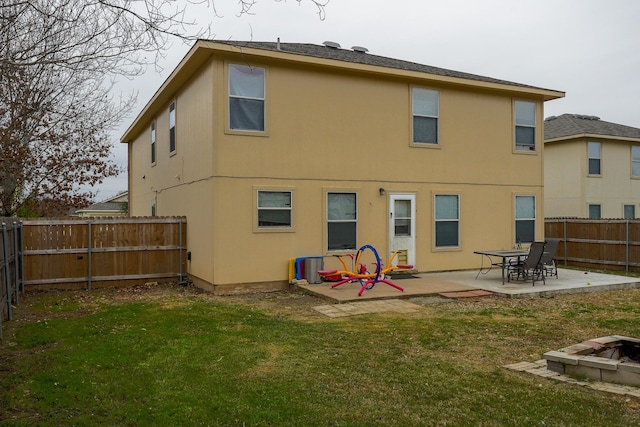 rear view of property with a lawn and a patio area