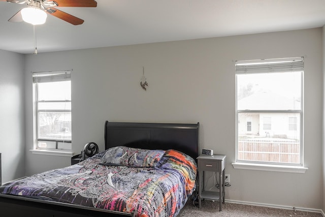 bedroom featuring ceiling fan and carpet