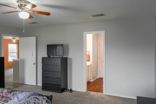 carpeted bedroom featuring ensuite bathroom and ceiling fan