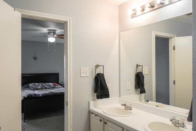 bathroom with ceiling fan and vanity