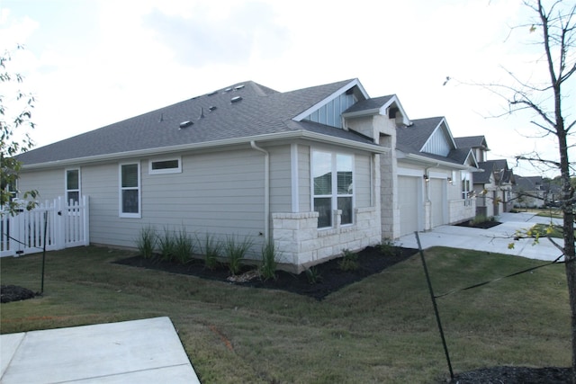 view of property exterior with a garage and a yard