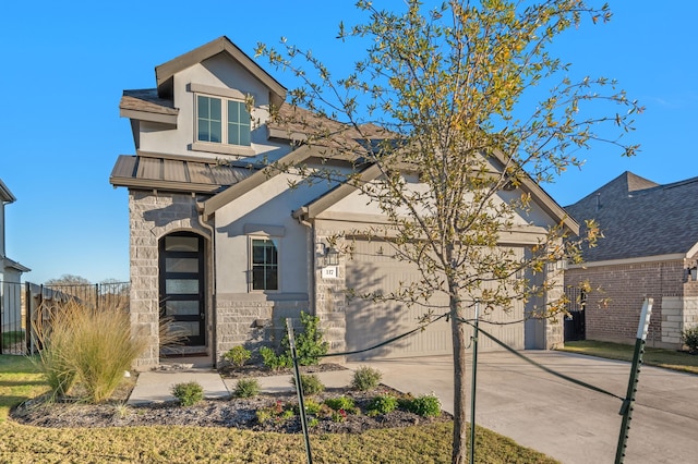 view of front facade with stone siding, stucco siding, fence, metal roof, and concrete driveway