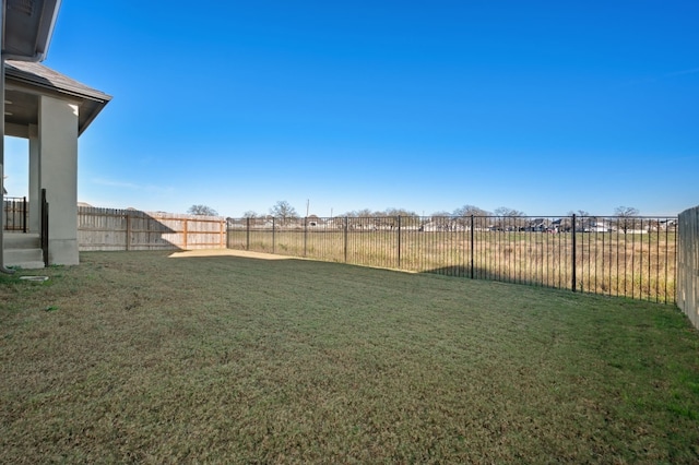 view of yard with a fenced backyard