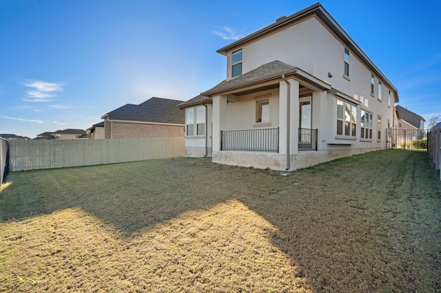 rear view of house with a lawn