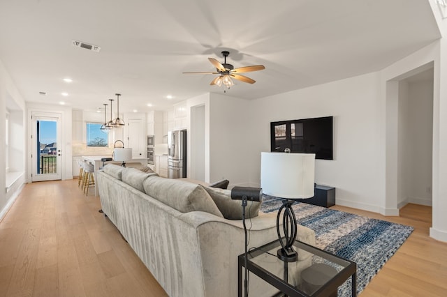117 Dycus Bnd, Liberty Hill, TX 78642 - living area with light wood-style flooring, ceiling fan, baseboards, and recessed lighting