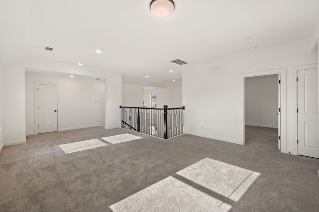 unfurnished room with baseboards, recessed lighting, visible vents, and light colored carpet