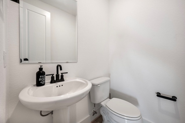 bathroom featuring sink and toilet