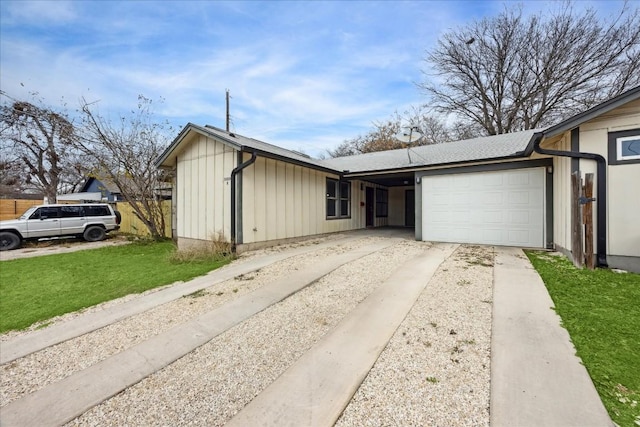 5300 Mccandless St, Austin, TX 78756 - view of front of house featuring board and batten siding, a garage, concrete driveway, and a front lawn